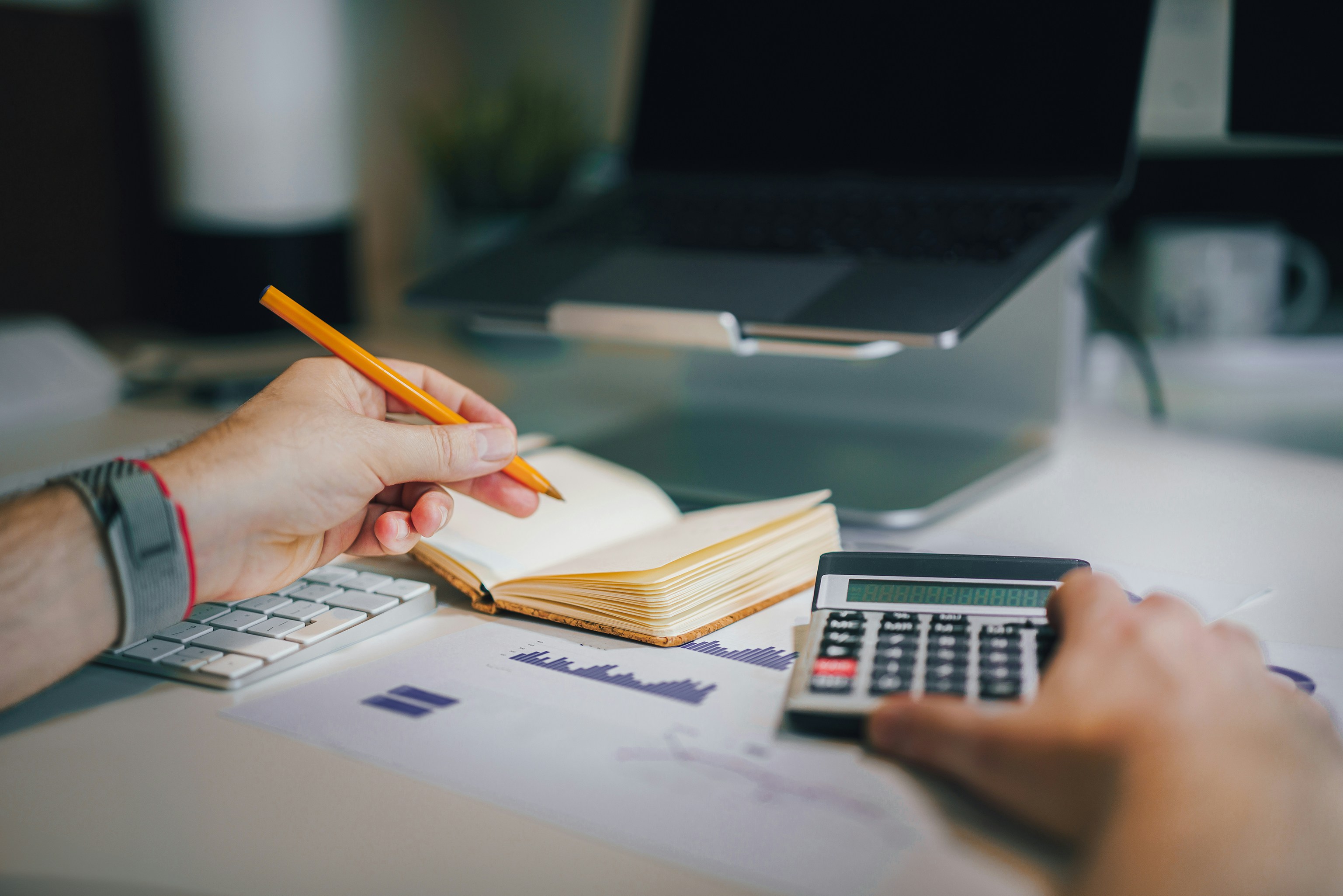 Financial charts and calculator on desk